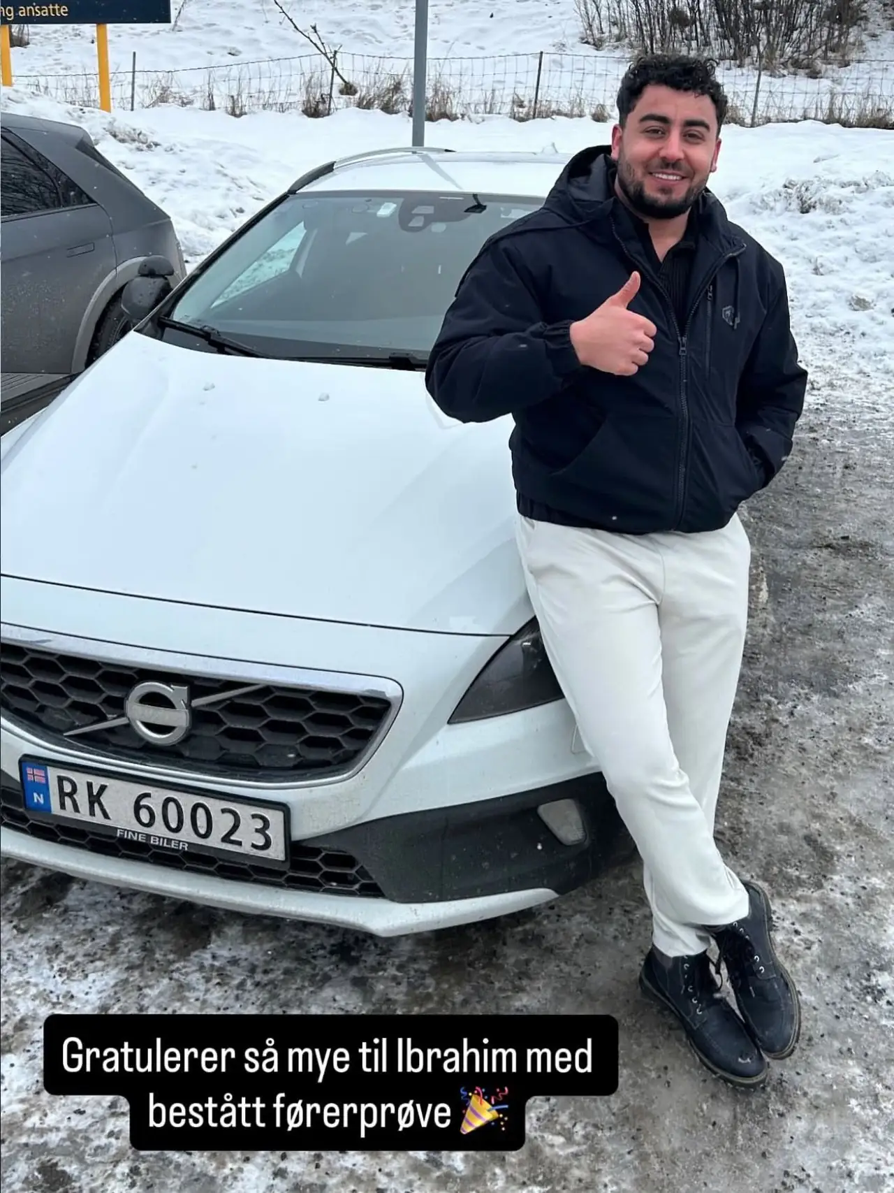 Ibrahim ved skolens Volvo etter bestått førerprøve