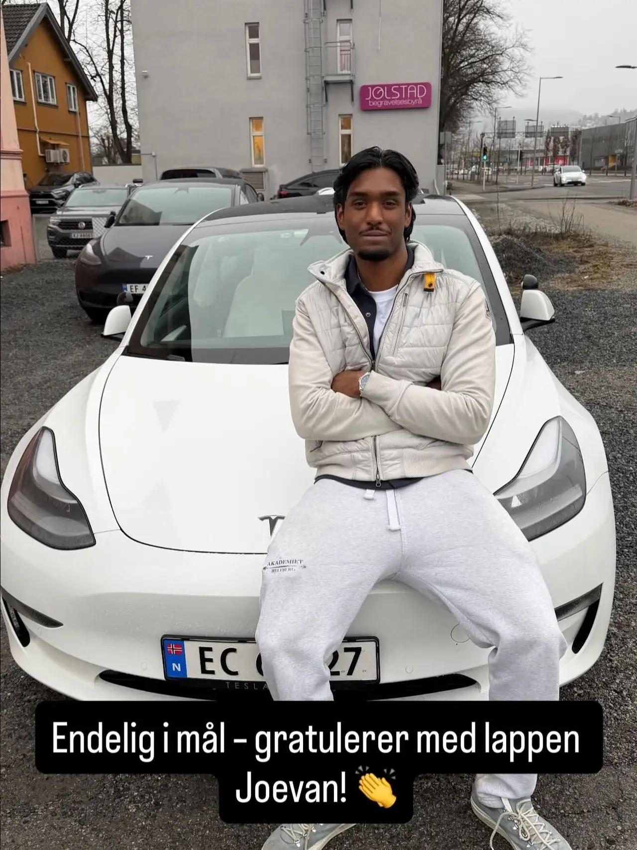 Joevan foran skolens Tesla etter bestått førerprøve